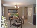 Bright dining room with a round table set, chandelier, and neutral color palette at 3811 Elmwood Dr, Holiday, FL 34691