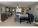 Comfortable living room with neutral walls, tile floor, and an abundance of decor at 3811 Elmwood Dr, Holiday, FL 34691