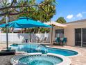 Inviting backyard pool and spa area, perfect for relaxation and entertaining, with nearby patio seating at 429 87Th Ave, St Pete Beach, FL 33706