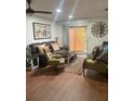 Inviting living room with hardwood floors, comfortable seating, and sliding glass doors at 6446 71St N St, Pinellas Park, FL 33781