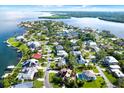 Breathtaking aerial view showcases a waterfront community with homes, canals, and lush landscaping on the coast at 101 Carlyle Dr, Palm Harbor, FL 34683