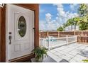 Welcoming front entrance featuring a stylish door and a beautiful white picket fence at 10520 Winrock Pl, Tampa, FL 33624