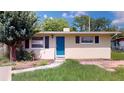 Inviting single-story home with a well-maintained front lawn and blue door at 12113 Victory Dr, Hudson, FL 34667
