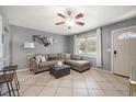 Comfortable living room with a ceiling fan, tile floors, and a sectional sofa at 124 E Virginia Ln, Clearwater, FL 33759