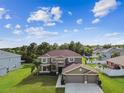 Aerial view of the house with lush landscaping, mature trees and nice backyard at 12915 Carlington Ln, Riverview, FL 33579