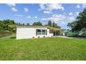Charming single-story home with a covered carport, neat landscaping, and freshly cut green grass at 2017 Waikiki Way, Tampa, FL 33619