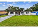 A welcoming single-story house with a green lawn and simple, elegant landscaping at 2027 Balfour Cir, Tampa, FL 33619