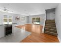 Open-concept living room with hardwood floors, lots of natural light, and convenient access to the backyard pool at 208 Se Lincoln N Cir, St Petersburg, FL 33703