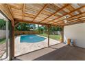 Relaxing covered patio overlooking the sparkling pool and lush backyard, perfect for outdoor entertaining at 208 Se Lincoln N Cir, St Petersburg, FL 33703