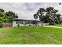 Charming single-story home with a well-manicured lawn, brick driveway, and light blue exterior at 2192 Robinson Dr, St Petersburg, FL 33710