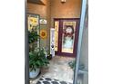 Inviting entryway with decorative signs, plants, and a charming welcome sign at 29524 Waggle Dr, San Antonio, FL 33576