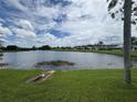 Scenic view of lake surrounded by lush greenery and blue skies with clouds at 29524 Waggle Dr, San Antonio, FL 33576