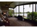 Enclosed patio featuring brick pavers and lovely lake view at 29524 Waggle Dr, San Antonio, FL 33576