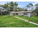 Expansive backyard featuring a lush lawn and playground equipment, perfect for outdoor entertainment and Gathering fun at 36251 Horseshoe Dr, Zephyrhills, FL 33541