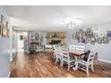 Spacious living and dining area showcasing a stone fireplace, wood floors, and a view of a doorway at 36251 Horseshoe Dr, Zephyrhills, FL 33541