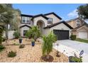 Home exterior with stone landscaping, mature trees and plants, and a two-car garage at 4738 Bloom Dr, Plant City, FL 33566