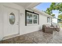Inviting front porch with stylish outdoor seating and decorative tile flooring for relaxing outdoors at 4741 76Th N Ave, Pinellas Park, FL 33781