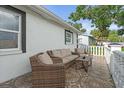Inviting front porch with stylish outdoor seating, white fencing and decorative tile flooring at 4741 76Th N Ave, Pinellas Park, FL 33781
