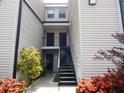 Exterior view of condo building with black stairs leading to the entrances at 4811 Puritan Cir # 4811, Tampa, FL 33617