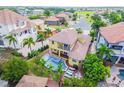 Expansive aerial view showcases the pool, spa, and backyard of the property surrounded by lush landscaping at 539 Treviso Dr, Apollo Beach, FL 33572