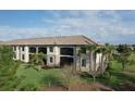 A beautiful aerial view of the property showing lush green lawn, landscaping, and architectural details at 5720 Palmer Cir # 102, Bradenton, FL 34211
