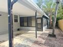 Spacious, covered back porch area with brick and concrete flooring, perfect for outdoor entertaining at 6427 2Nd S Ave, St Petersburg, FL 33707