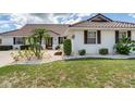Attractive home with manicured lawn, professional landscaping, and a tile roof at 702 Plumbrook Rd, Sun City Center, FL 33573