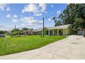 Well-maintained single-story home with a long driveway and inviting front porch at 7308 Avonwood St, Tampa, FL 33625