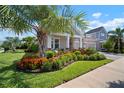 Charming single-Gathering home featuring lush landscaping, a well-manicured lawn, and a welcoming entrance at 7520 Paradiso Dr, Apollo Beach, FL 33572