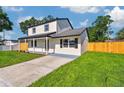 Stylish two-story home with a green lawn, complemented by a well-maintained landscape at 7806 N Matanzas Ave, Tampa, FL 33614