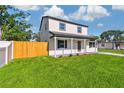 Inviting two-story home featuring a well-manicured lawn and stylish exterior at 7806 N Matanzas Ave, Tampa, FL 33614