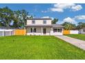 Beautiful two-story home with a lush green lawn and a welcoming front porch at 7806 N Matanzas Ave, Tampa, FL 33614