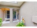 Charming front entryway with decorative welcome sign and lovely plants at 8251 118Th Ave # 8251, Largo, FL 33773