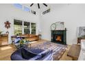 Spacious living room features a fireplace, hardwood floors, and lots of natural light at 8843 Kenton Rd, Wesley Chapel, FL 33545