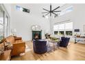 Bright living room boasts high ceilings, large windows, fireplace, and hardwood floors at 8843 Kenton Rd, Wesley Chapel, FL 33545