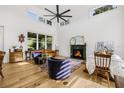 Bright and airy living room features high ceilings, a fireplace, and hardwood floors at 8843 Kenton Rd, Wesley Chapel, FL 33545