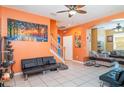 Living room features tiled floors, modern decor, and multiple sofas for ample seating at 915 Windton Oak Dr, Ruskin, FL 33570