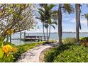 Lush waterfront property with a wooden dock for boat access at 11055 7Th E St, Treasure Island, FL 33706