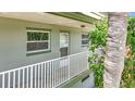 Second story walkway and front door of a condo unit with lush landscaping at 1433 S Belcher Rd # B11, Clearwater, FL 33764