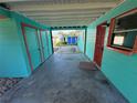 Carport with painted walls and storage room at 1504 Stevensons Dr, Clearwater, FL 33755
