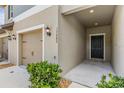 Inviting entryway showcasing the front door, garage access, and manicured landscaping at 17482 Nectar Flume Dr, Land O Lakes, FL 34638