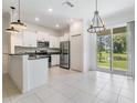 Modern kitchen features stainless steel appliances and a view of the tranquil pond at 17482 Nectar Flume Dr, Land O Lakes, FL 34638