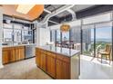 Open kitchen with stainless steel appliances, center island, and large windows offering a stunning city view at 175 2Nd St S # P-2, St Petersburg, FL 33701
