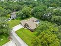 Aerial view of home with screened in pool and lush landscaping at 2409 Heather Manor Ln, Lutz, FL 33549