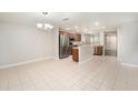Spacious kitchen with stainless steel appliances and large tile flooring, perfect for cooking and entertaining at 2570 Sea Wind Way, Clearwater, FL 33763