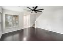 Bright living room with hardwood floors, ceiling fan and staircase at 2570 Sea Wind Way, Clearwater, FL 33763