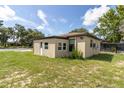 View of separate in-law suite with door, windows and beige exterior paint at 271 Eastpoint Ct, Spring Hill, FL 34606