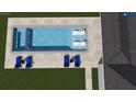 Aerial view of a rectangular in-ground pool featuring an outdoor shower and lounge chairs, and a waterfall feature at 4111 W Mullen Ave, Tampa, FL 33609