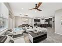 Spacious living room with a ceiling fan, open to the kitchen and dining areas at 4515 Bent Tree Blvd, Sarasota, FL 34241