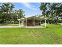 Covered patio featuring a neutral color, a concrete floor, and ample room for entertainment or relaxation at 4708 Bugg Rd, Plant City, FL 33567